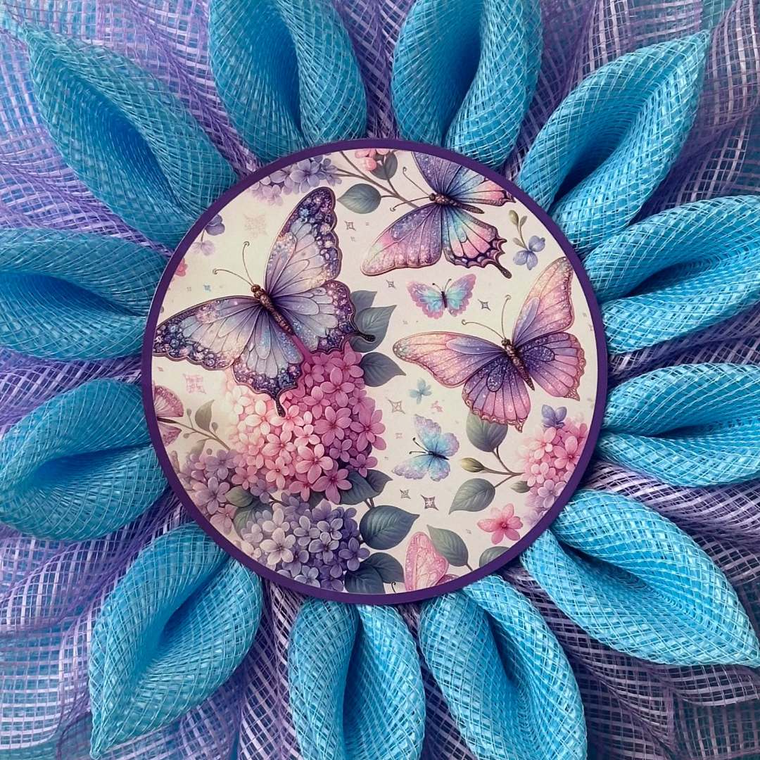 Deco Mesh flower wreath with blue and purple petals and a butterfly metal wreath sign by Monkey's Creations.