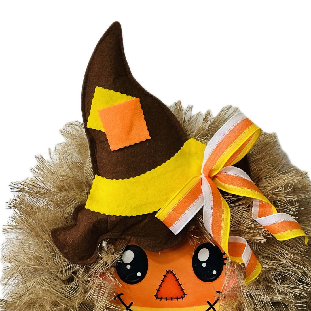 Autumn and Halloween candy corn themed scarecrow wreath with a candy corn scarecrow metal wreath sign center, frayed edge burlap, a felt hat and a candy corn colored bow by Monkey's Creations. 