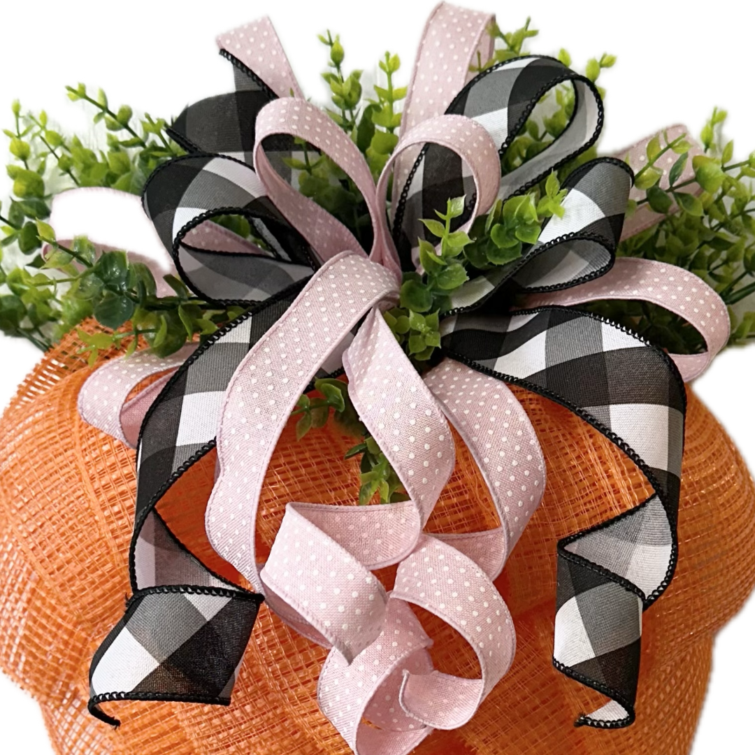 Decorative black white and pink ribbon bow and greenery 