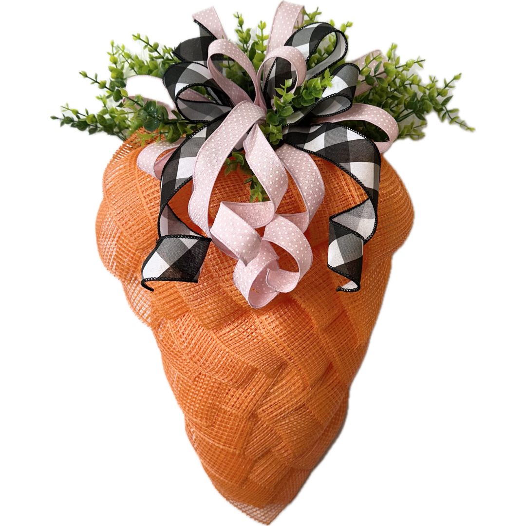 Decorative carrot with a ribbon bow and greenery 