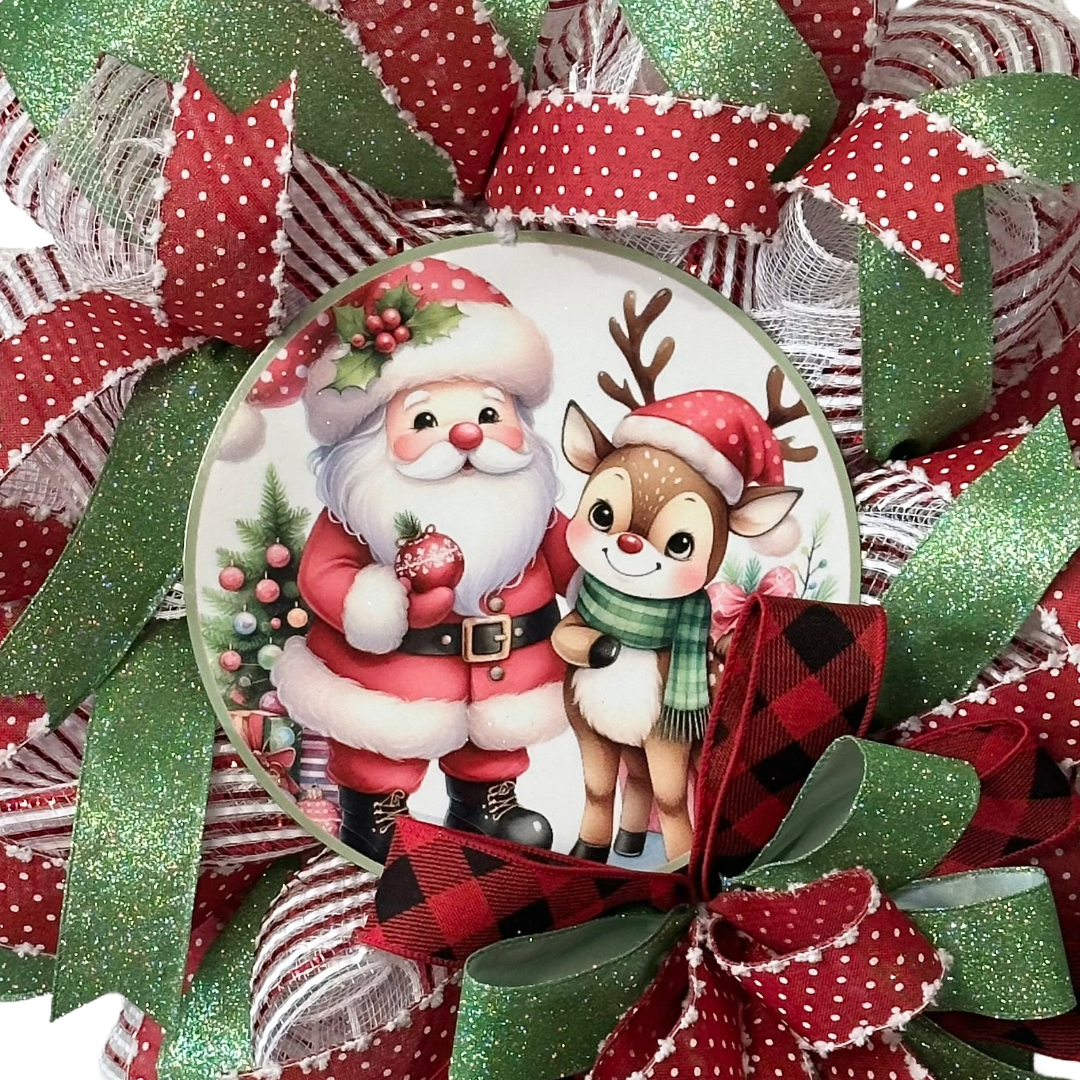 Deco mesh and wired ribbon wreath featuring red and green Christmas colors and a classic Santa and "Rudolph" inspired metal wreath sign center by Monkey's Creations. 