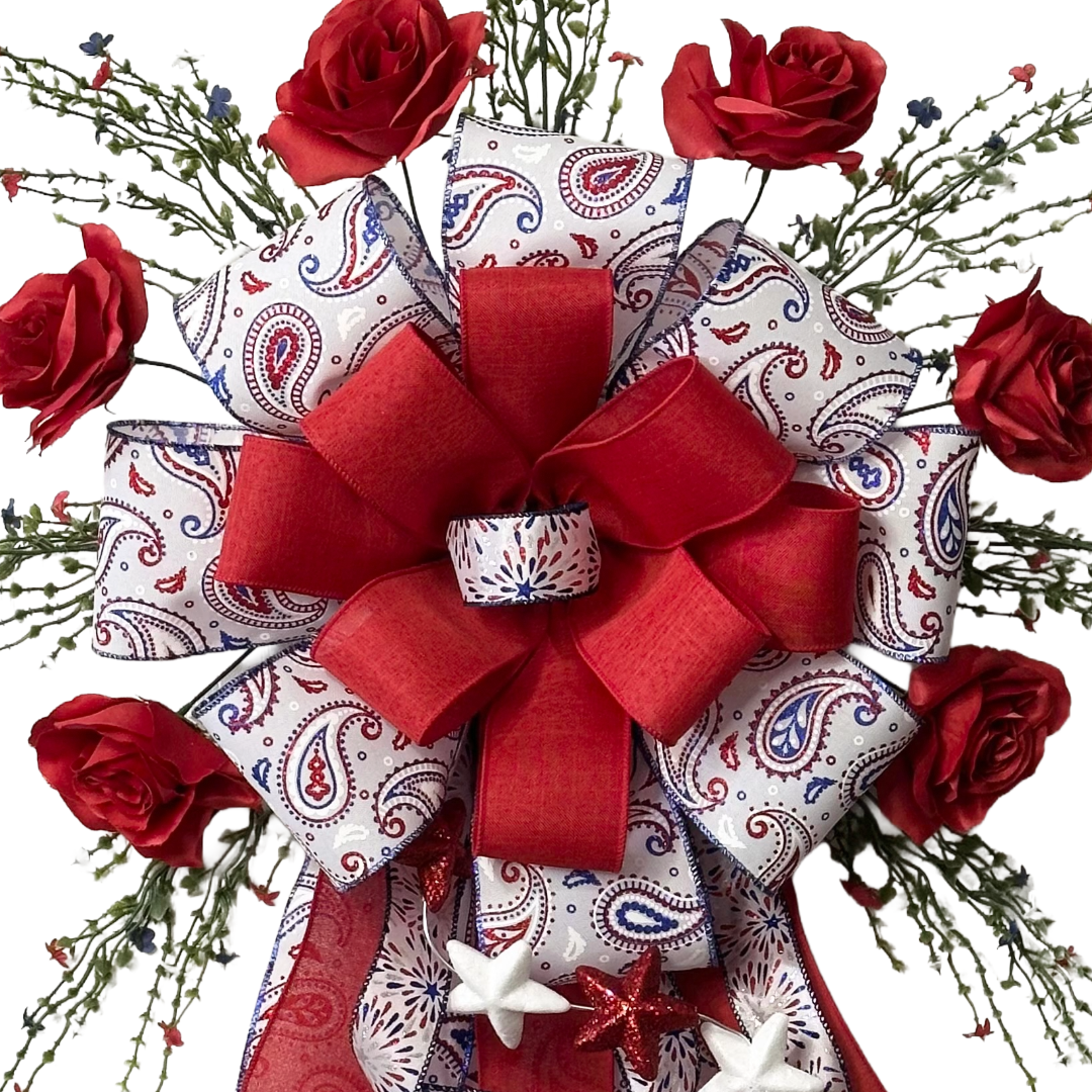 Patriotic themed giant bow with red roses, ribbons, greenery and stars 
