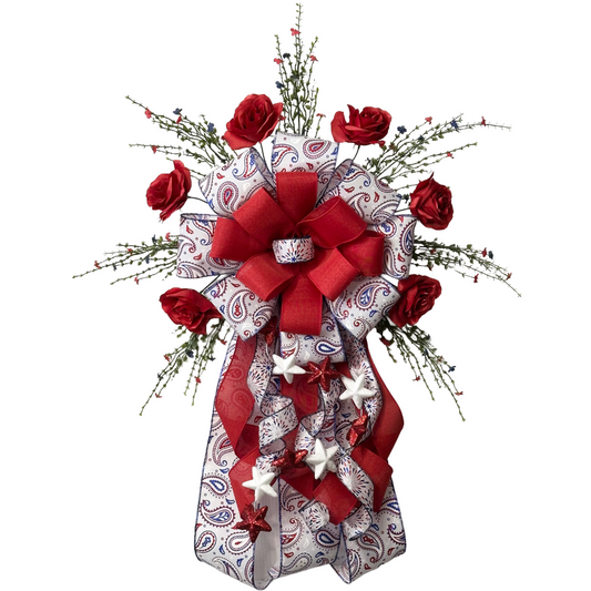 Patriotic themed giant bow with red roses, ribbons, greenery and stars 