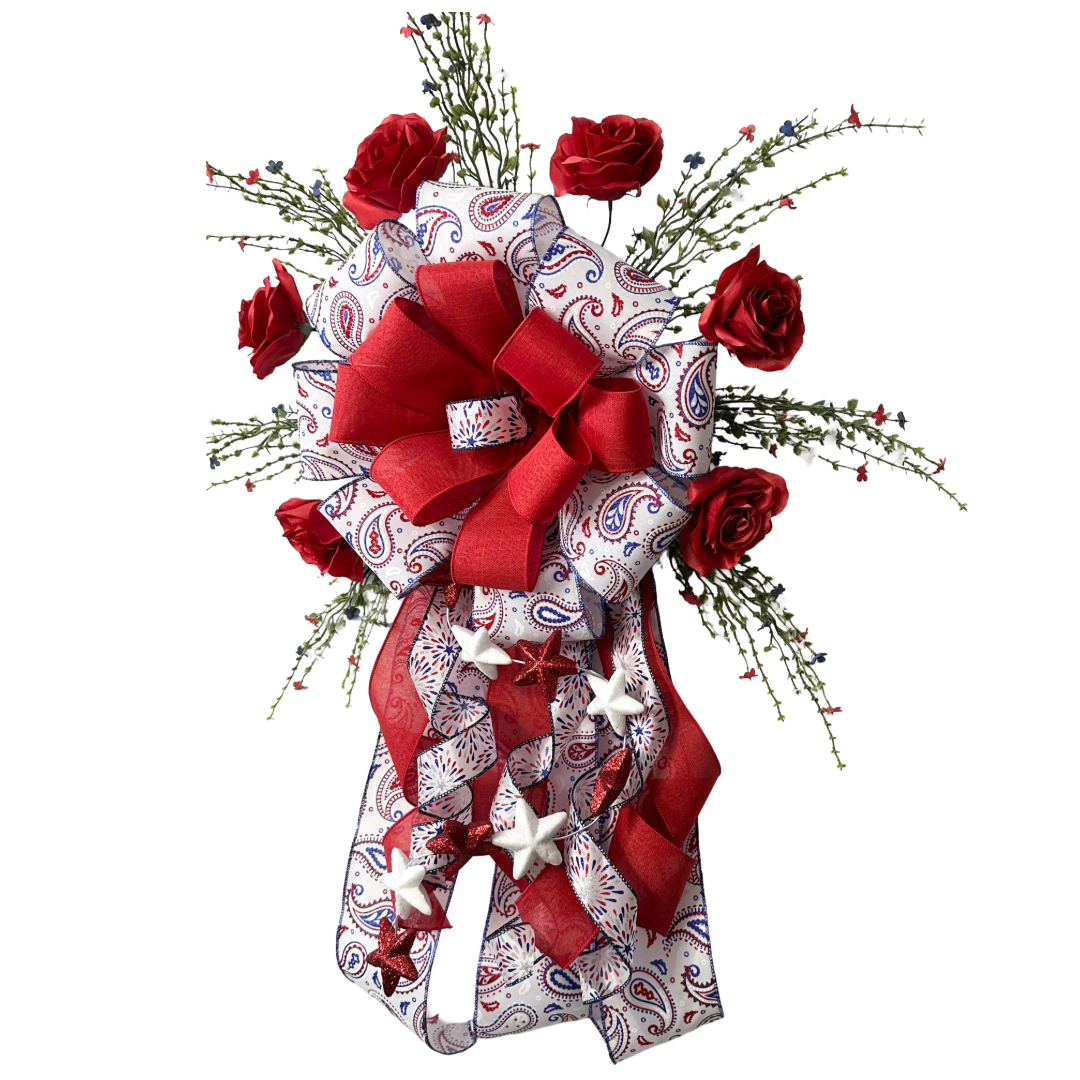 Patriotic themed giant bow with red roses, ribbons, greenery and stars 