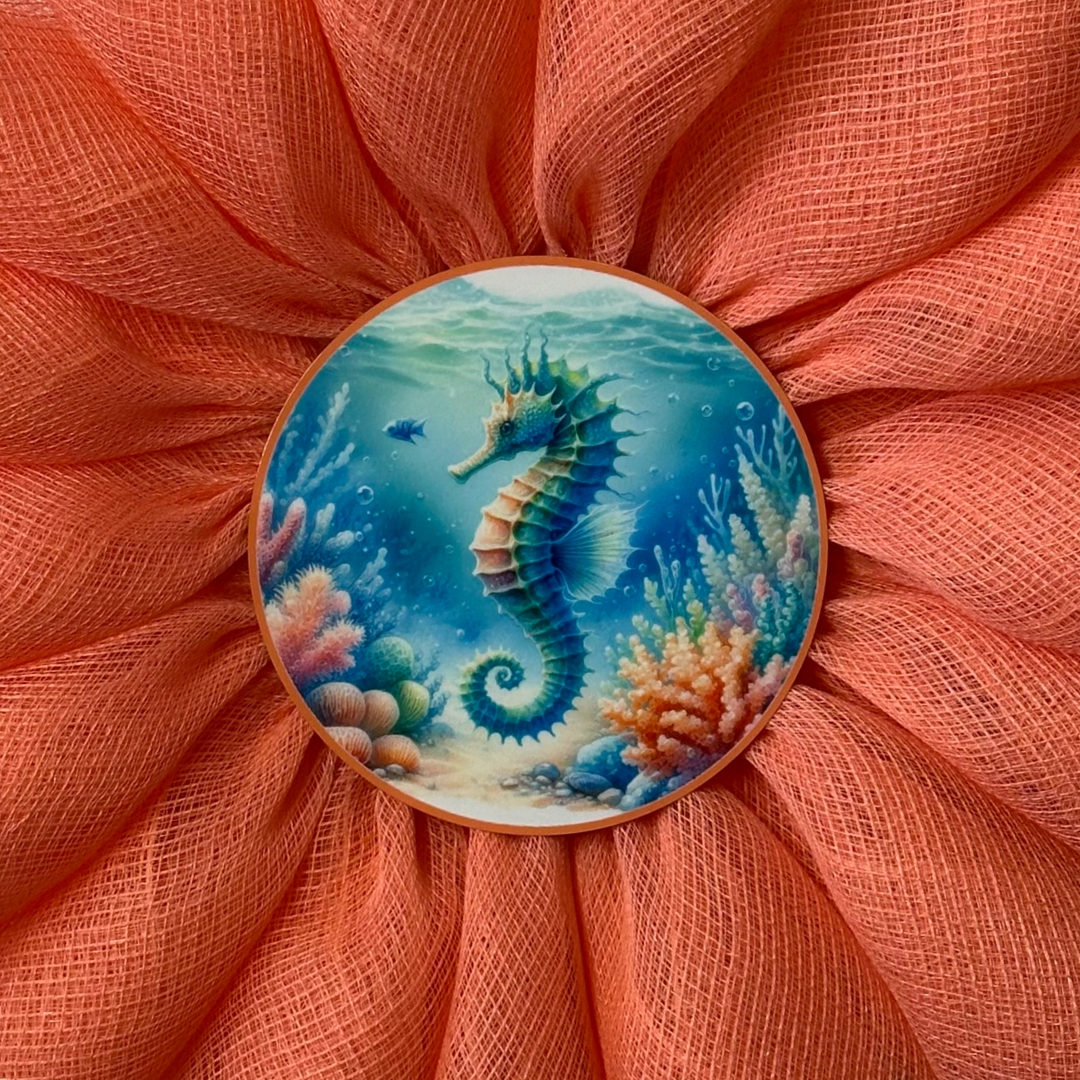 Coral-colored flower wreath with a seahorse design in the center by Monkey's Creations