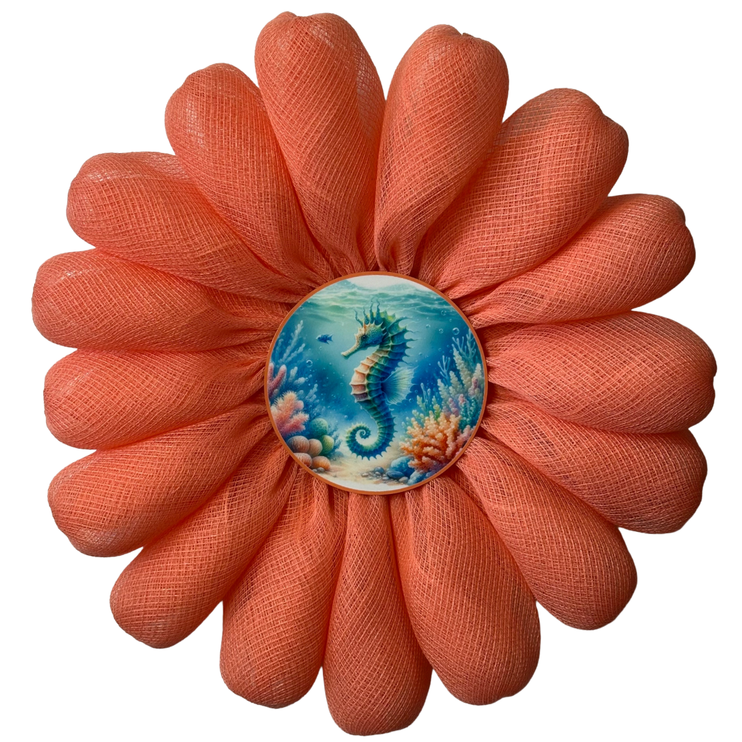 Coral-colored flower wreath with a seahorse design in the center by Monkey's Creations