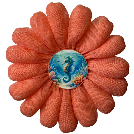 Coral-colored flower wreath with a seahorse design in the center by Monkey's Creations