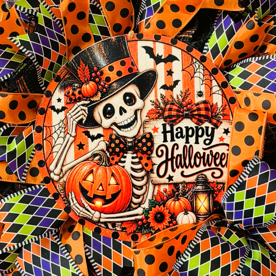 Orange, purple, black and lime green Halloween deco mesh and ribbon wreath featuring a round dapper skeleton with "happy Halloween" metal wreath sign and a large ribbon bow by Monkey's Creations. 