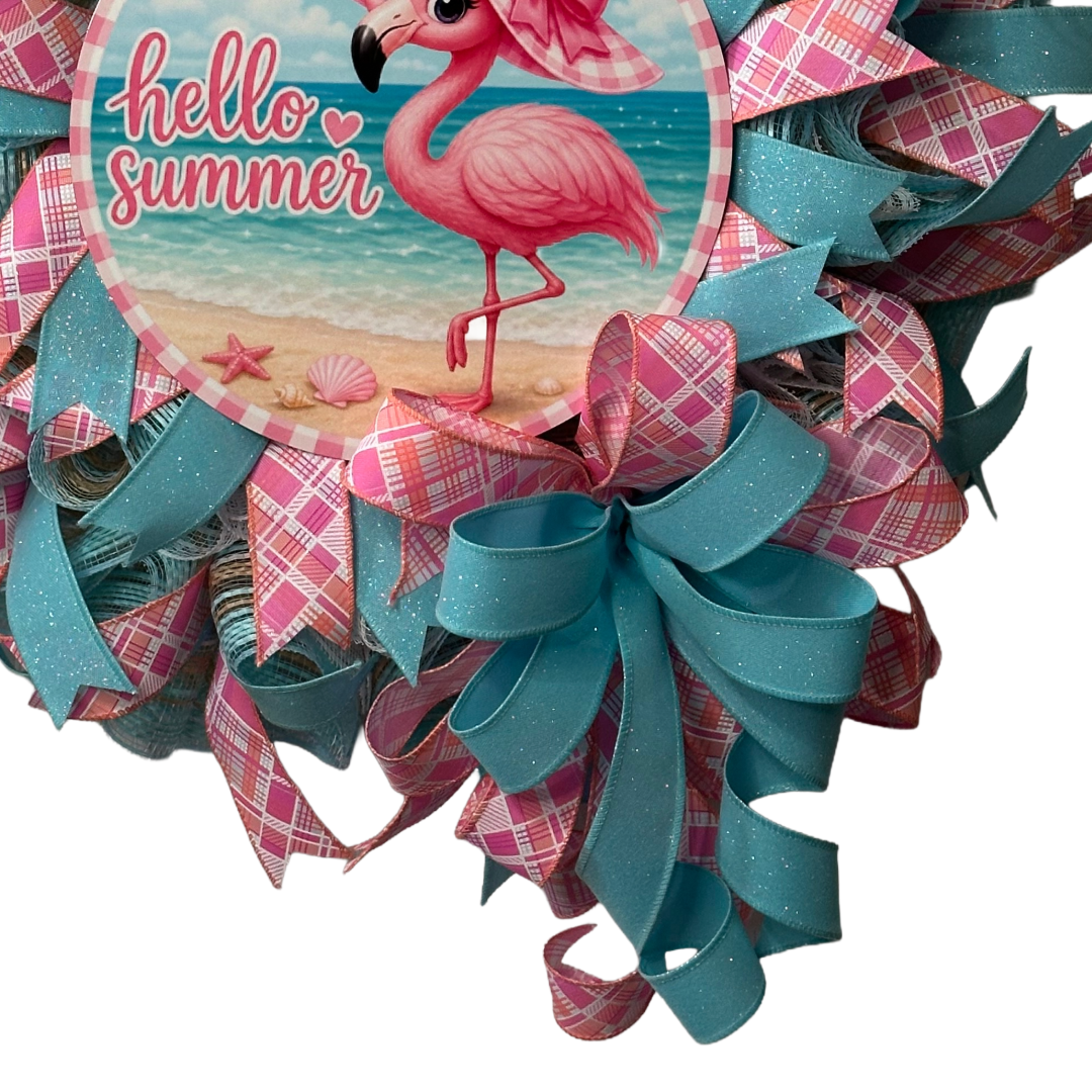 Deco mesh and ribbon wreath with a pink flamingo and 'hello summer' metal wreath sign center by Monkey's Creations. 