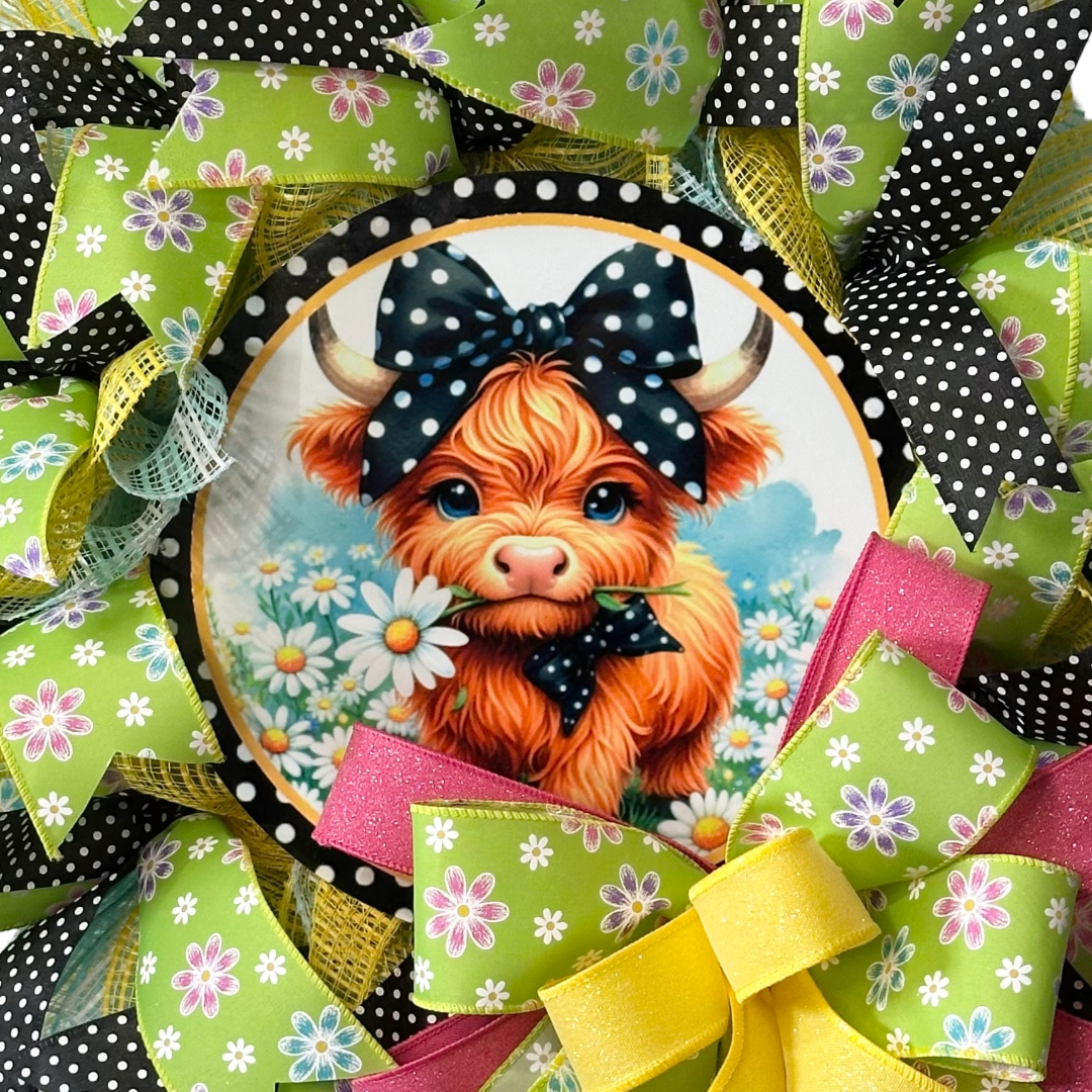 Farmhouse deco mesh and ribbon wreath with a highland cow center by Monkey's Creations. 