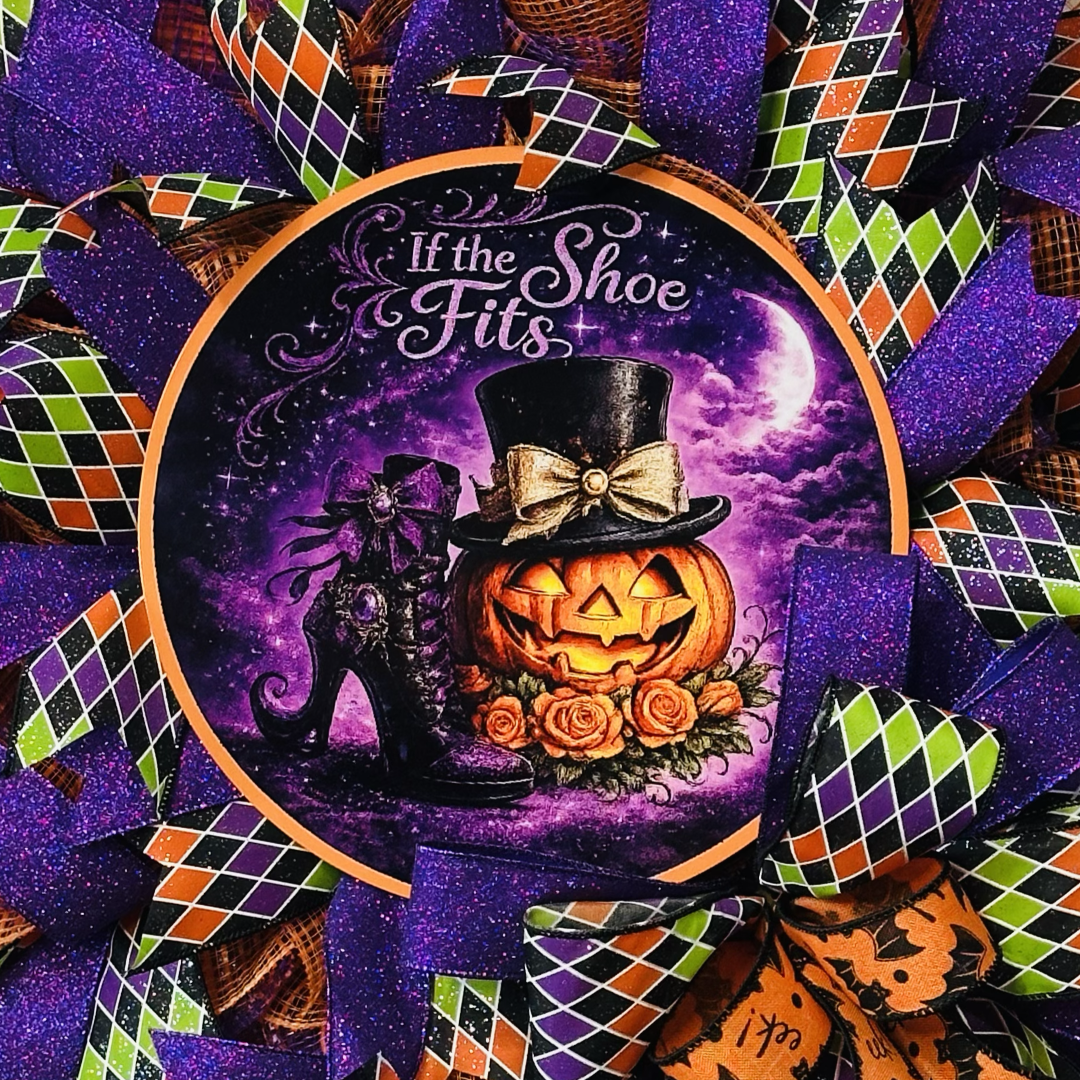 Orange, purple, green and black Halloween deco mesh and ribbon wreath featuring colorful bow and a metal wreath sign with the text "if the shoe fits" by Monkey's Creations.