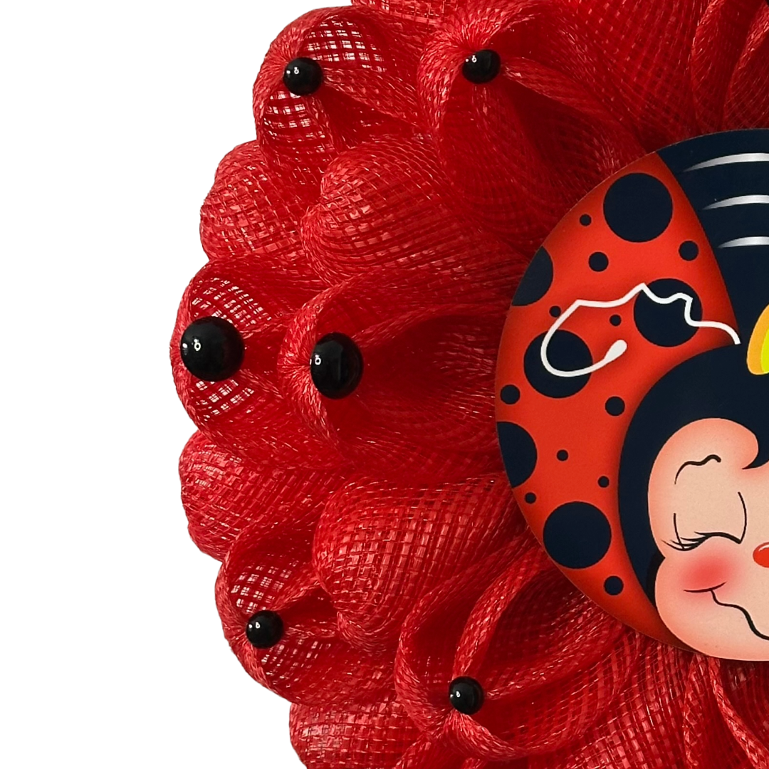 Ladybug inspired wreath with red deco mesh, black dots and a ladybug metal wreath sign in the center 