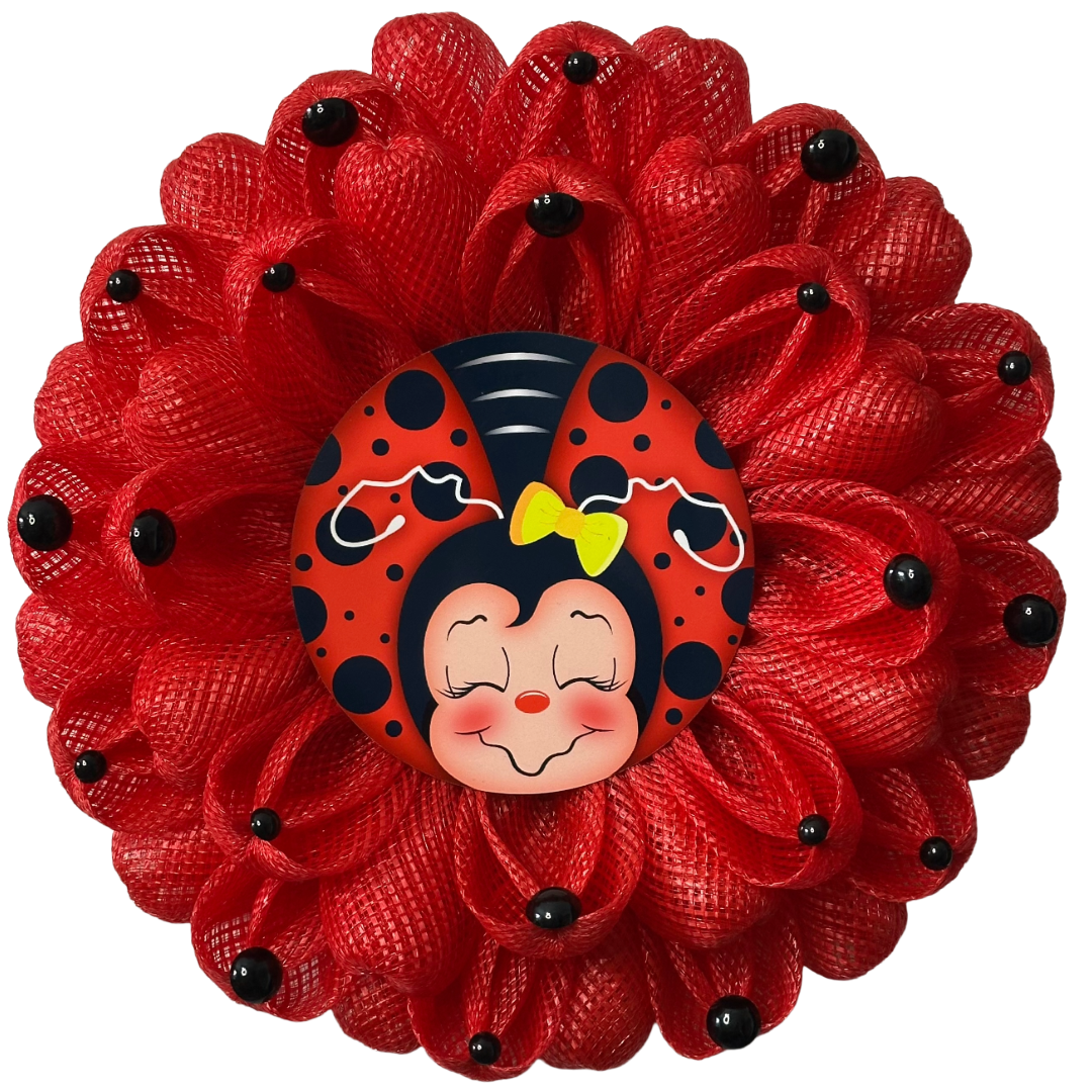 Ladybug inspired wreath with red deco mesh, black dots and a ladybug metal wreath sign in the center 