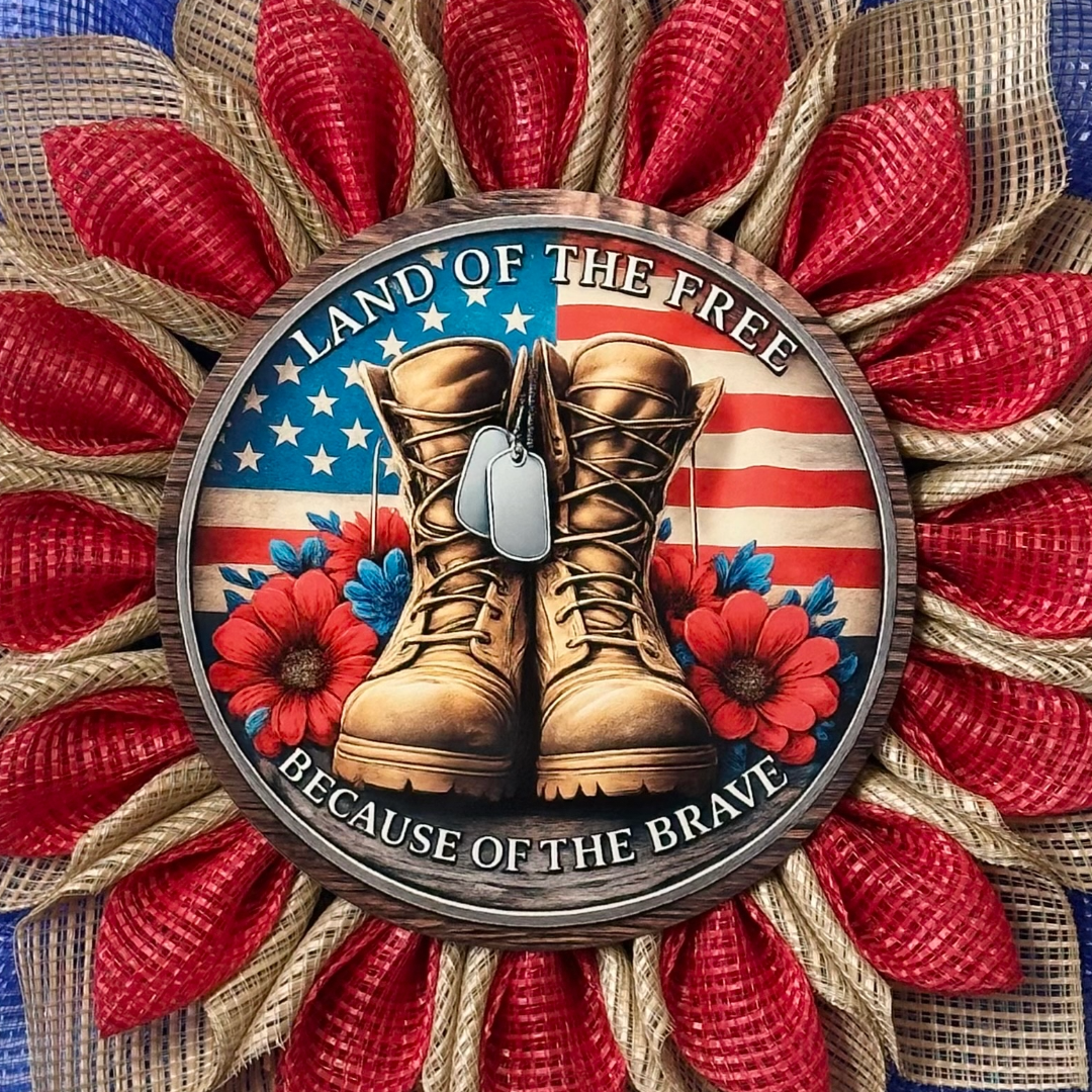 Red blue and natural flower wreath with a flag and veteran themed metal sign center with text "land of the free because of the brave" designed by Monkey's Creations