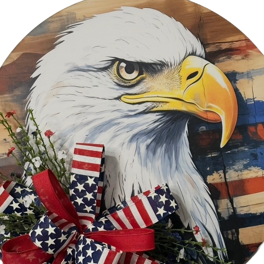 Patriotic eagle head door hanger with floral picks and a red white and blue themed ribbon bow by Monkey's Creations