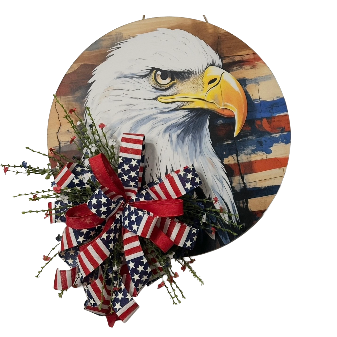 Patriotic eagle head door hanger with floral picks and a red white and blue themed ribbon bow by Monkey's Creations