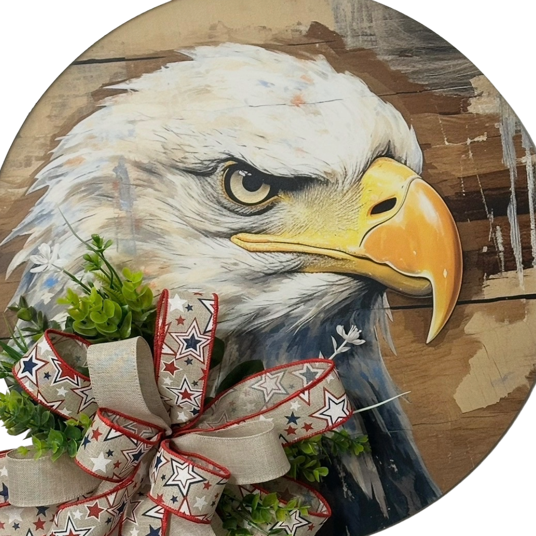 Patriotic eagle head door hanger with floral picks and a red white and blue themed ribbon bow by Monkey's Creations