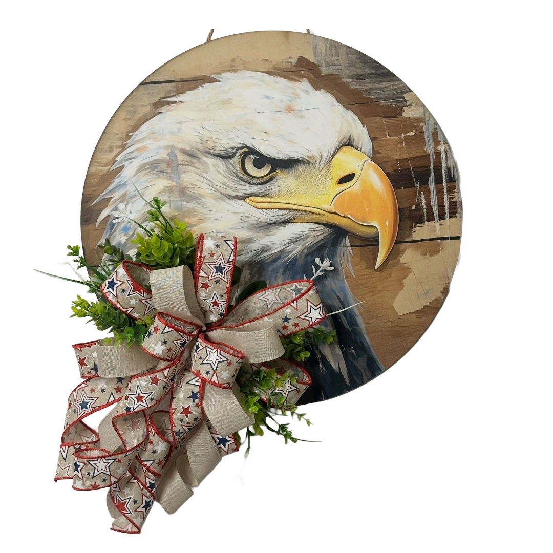 Patriotic eagle head door hanger with floral picks and a red white and blue themed ribbon bow by Monkey's Creations