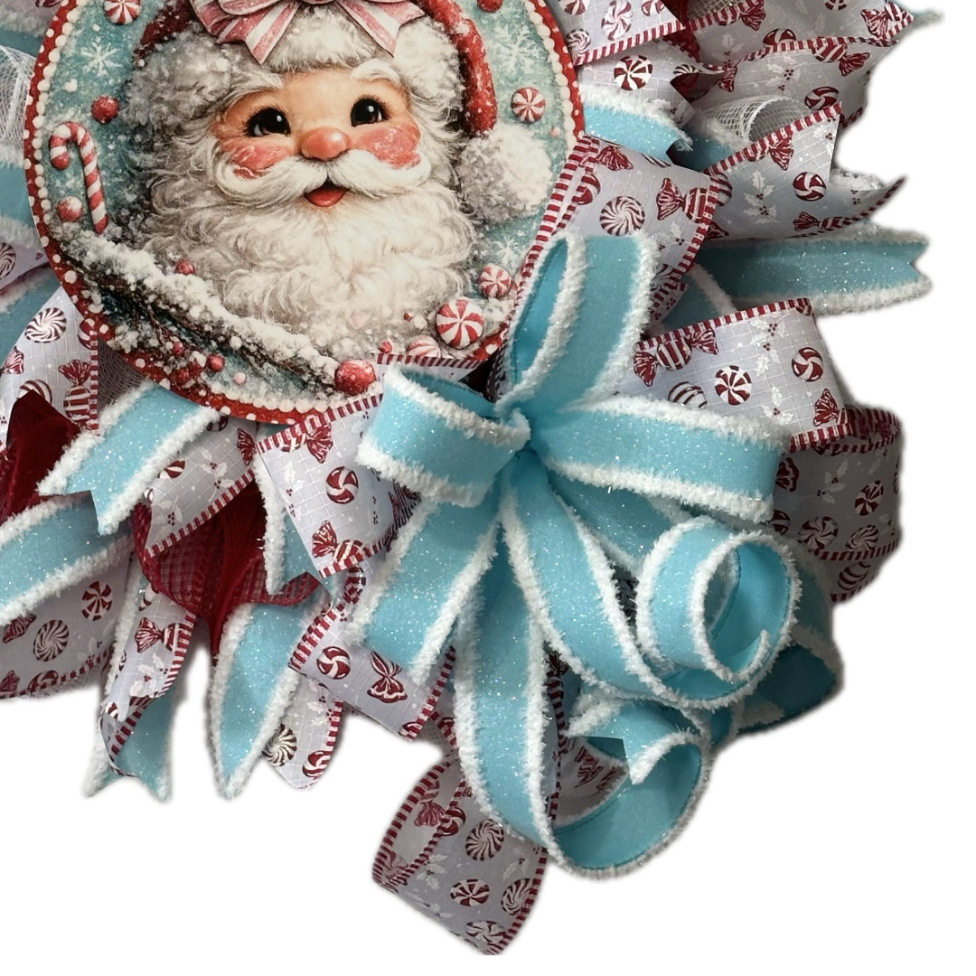 Deco mesh and ribbon wreath by Monkey's Creations featuring a peppermint candy themed light blue, red and white Santa Claus for Christmas