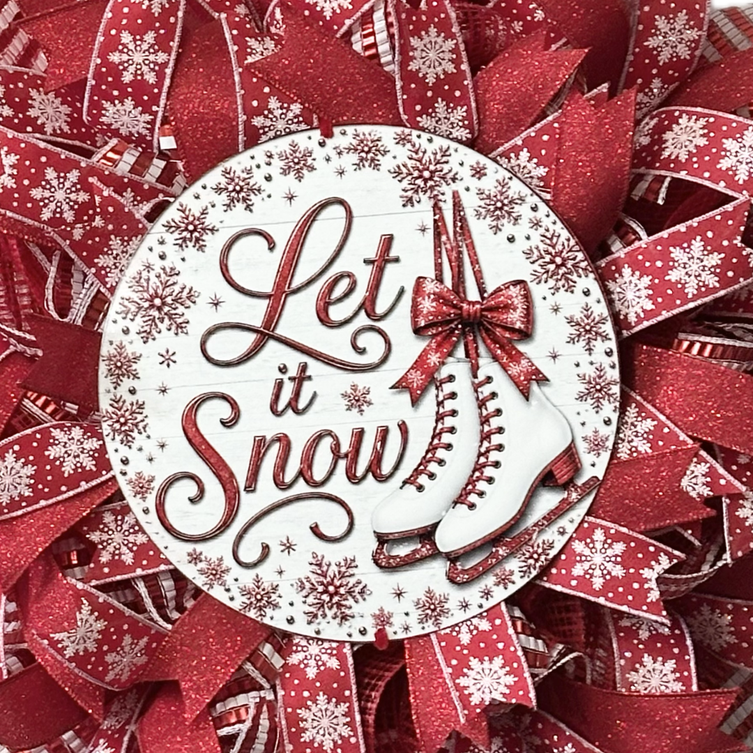 Red and white deco mesh and ribbon wreath featuring ice skates and "let it snow" by Monkey's Creations. 