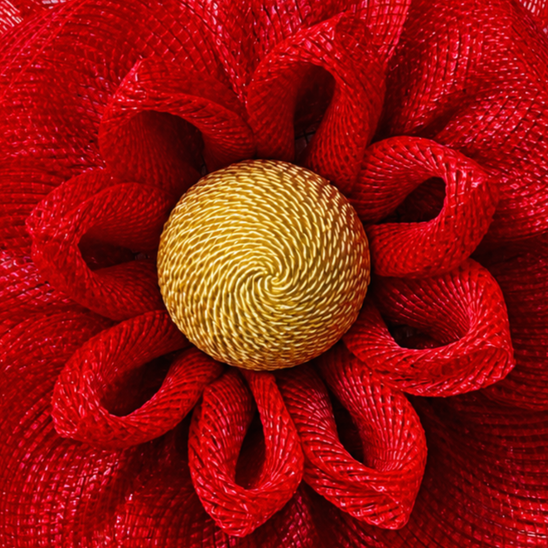 Red deco mesh magnolia flower wreath with a golden yellow rope center by Monkey's Creations. 