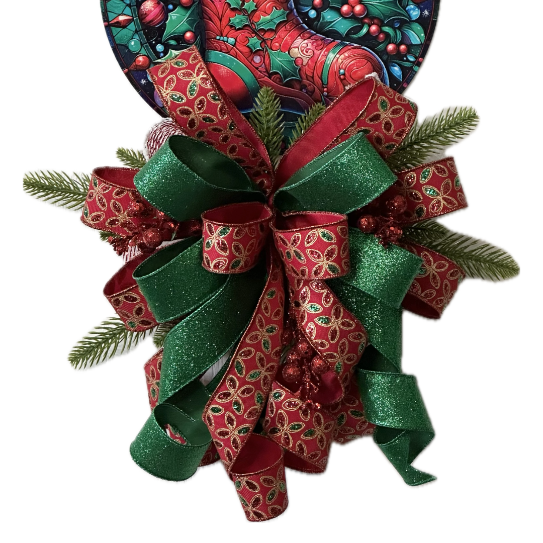 A festive Christmas wreath decoration featuring a red stocking metal wreath sign with candy canes, holly and berries, accented with a large red and green bow, faux glitter berries and faux pine branches by Monkey's Creations. 