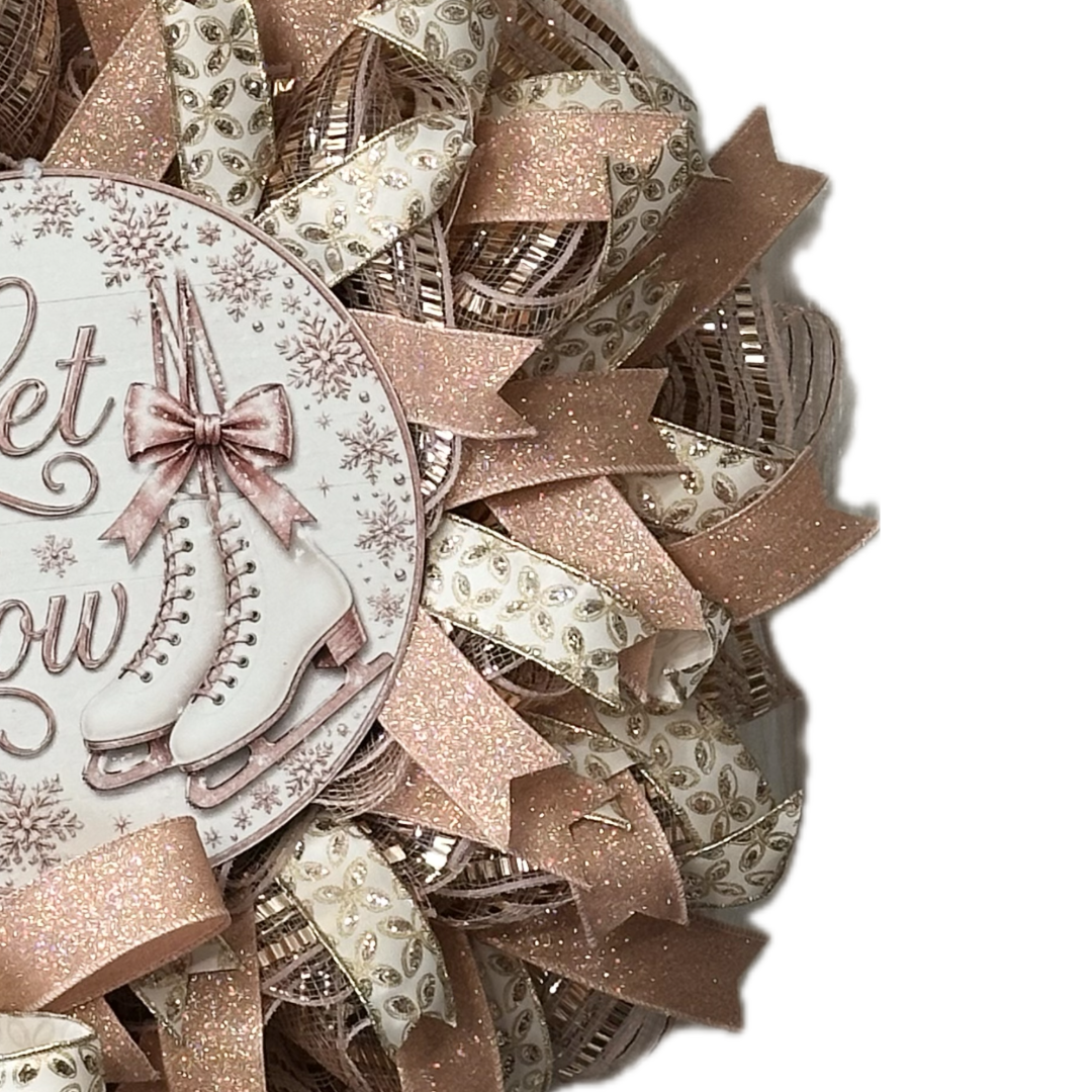 Rose gold deco mesh and ribbon wreath featuring ice skates and "let is snow" by Monkey's Creations. 