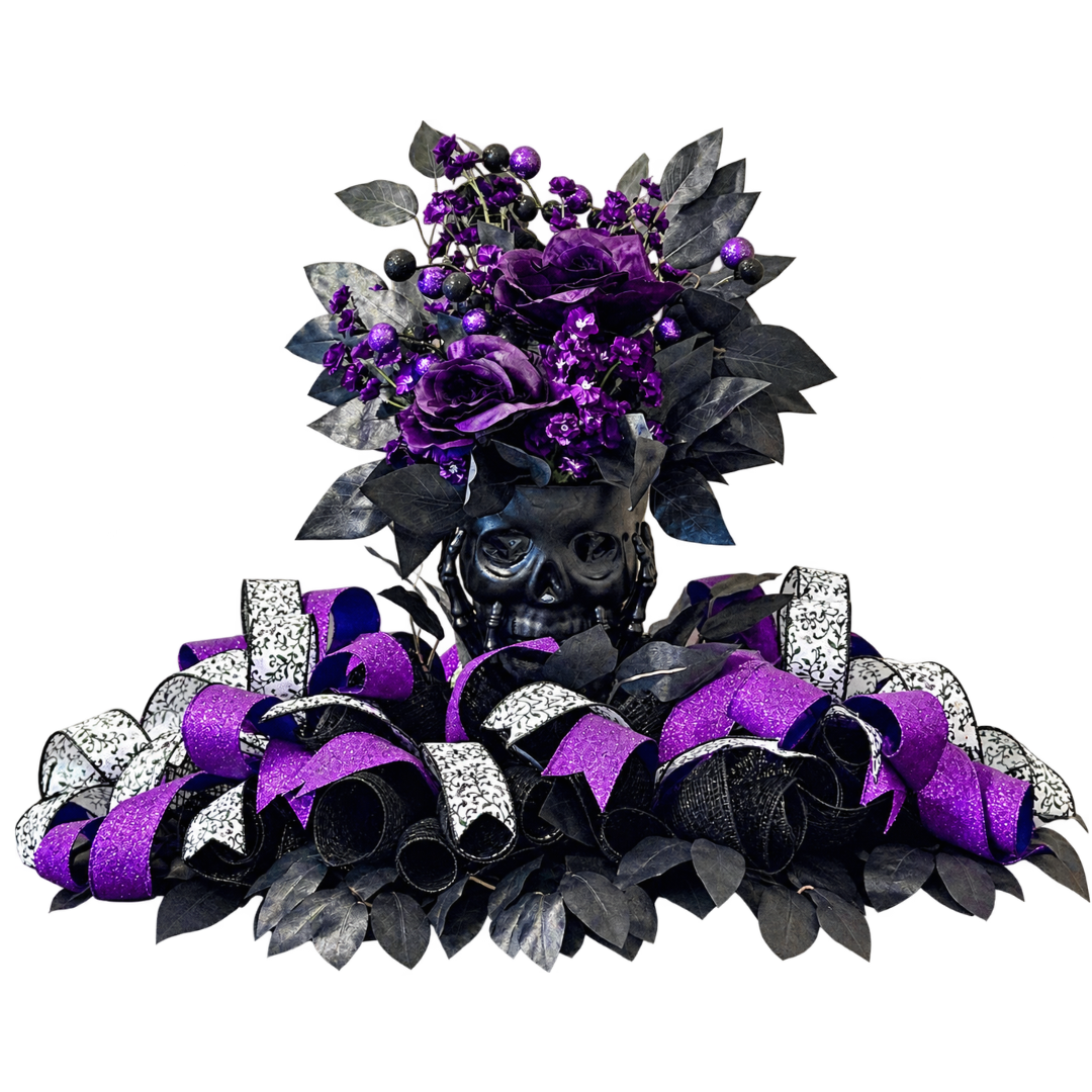 Black and purple themed Halloween skull centerpiece featuring floral picks, purple, black and white ribbon and black focus picks by Monkey's Creations. 