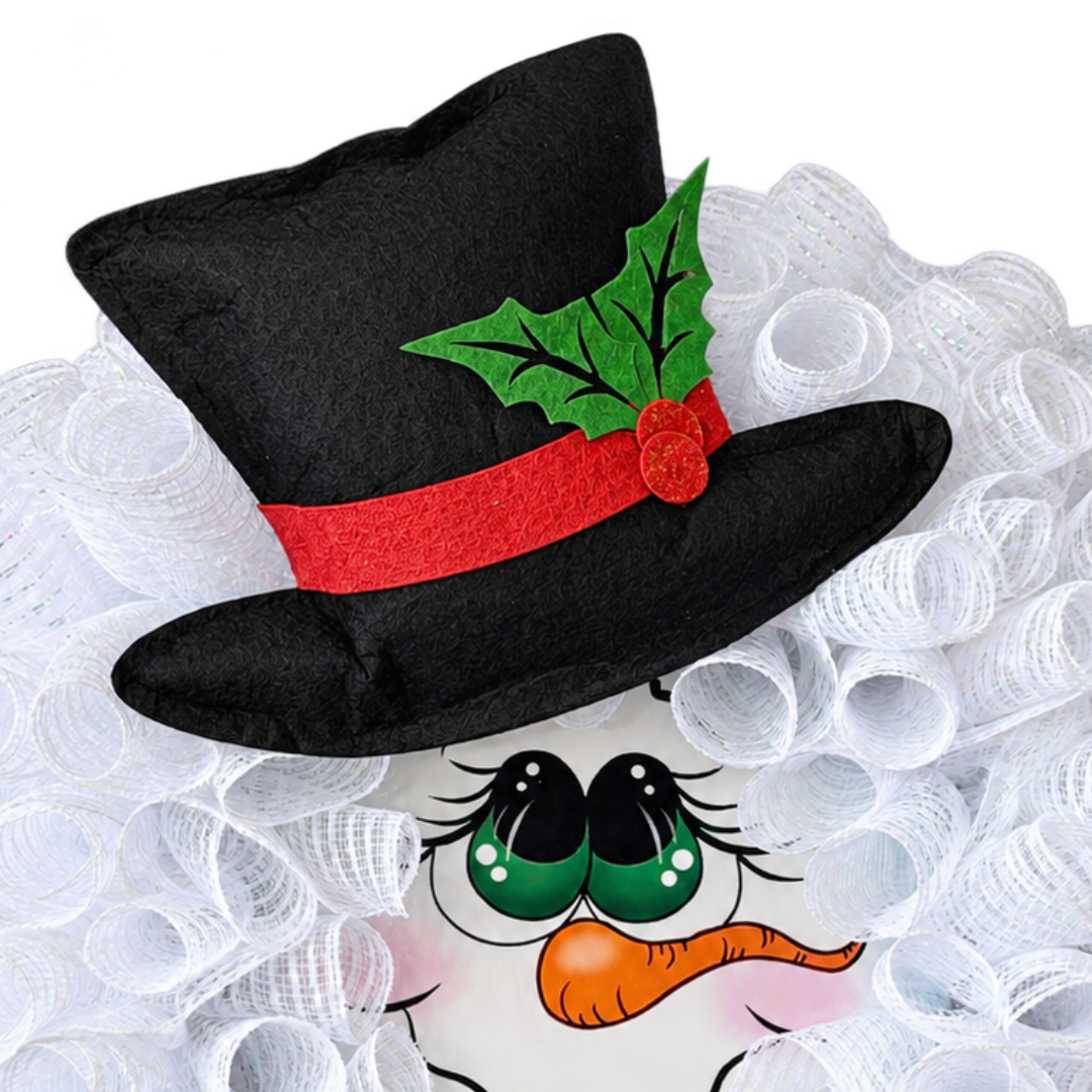 Deco mesh snowman character wreath by Monkey's Creations featuring white deco mesh, a felt top hat accented with holly berries and leaves and a argyle plaid bow. 