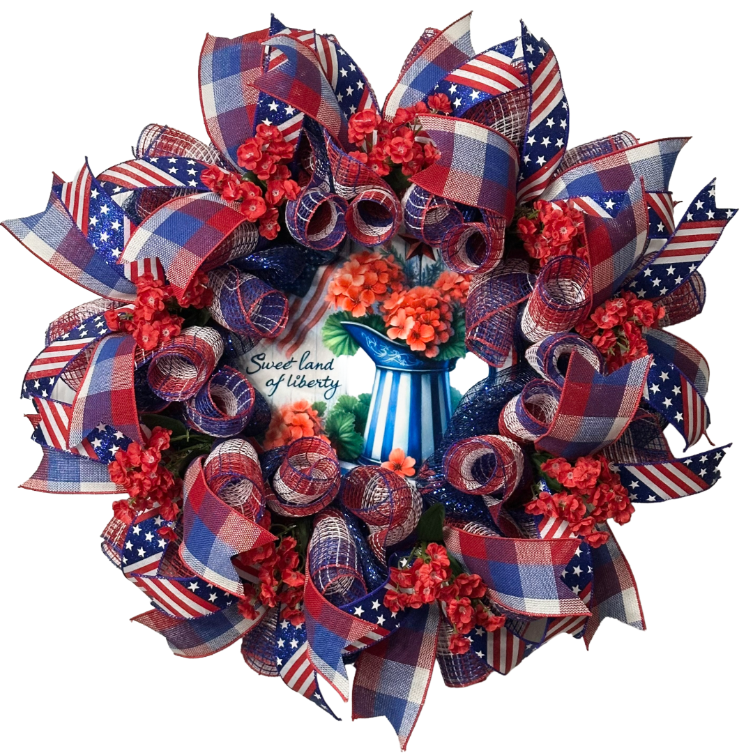 Deco mesh and ribbon wreath with red, white, and blue ribbons and flowers, featuring a 'Sweet Land of Liberty' by Monkey's Creations.