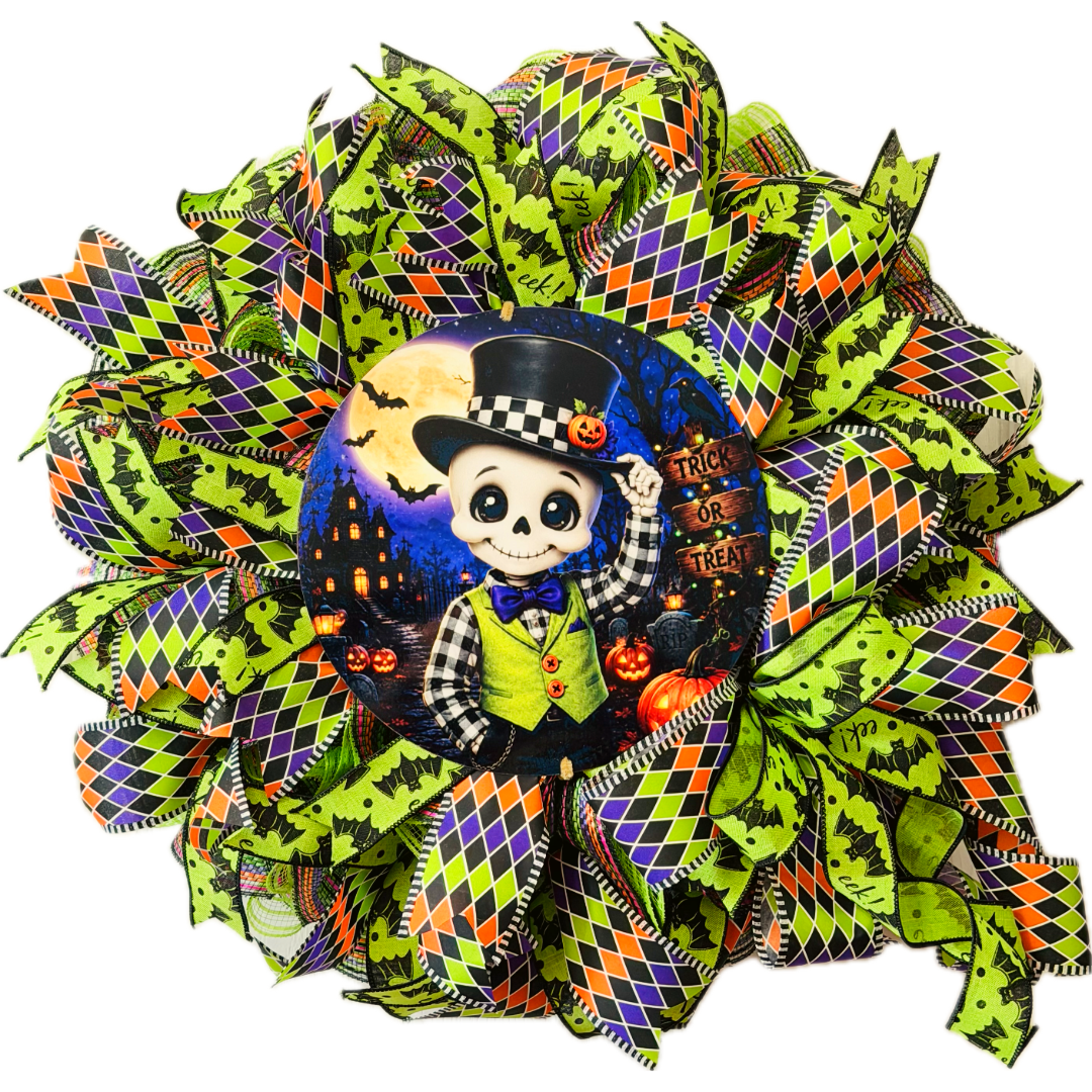 Orange, purple, black and lime green Halloween deco mesh and ribbon wreath featuring a round dapper skeleton with "trick or treat" metal wreath sign and a large ribbon bow by Monkey's Creations. 