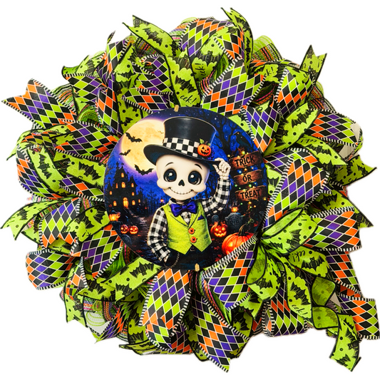 Orange, purple, black and lime green Halloween deco mesh and ribbon wreath featuring a round dapper skeleton with "trick or treat" metal wreath sign and a large ribbon bow by Monkey's Creations. 