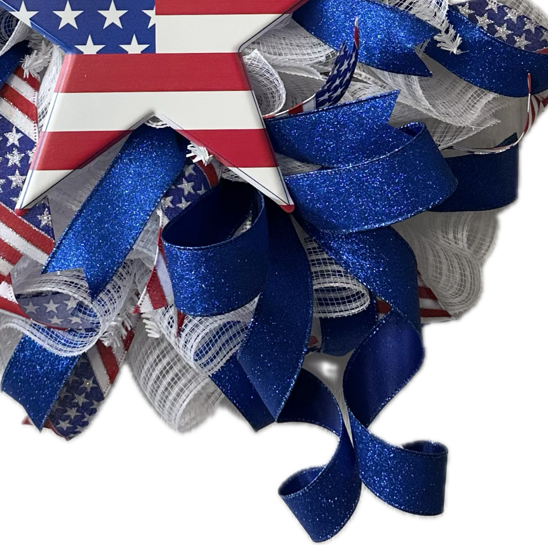 Decorative wreath with American flag design and blue, red, and white ribbons 