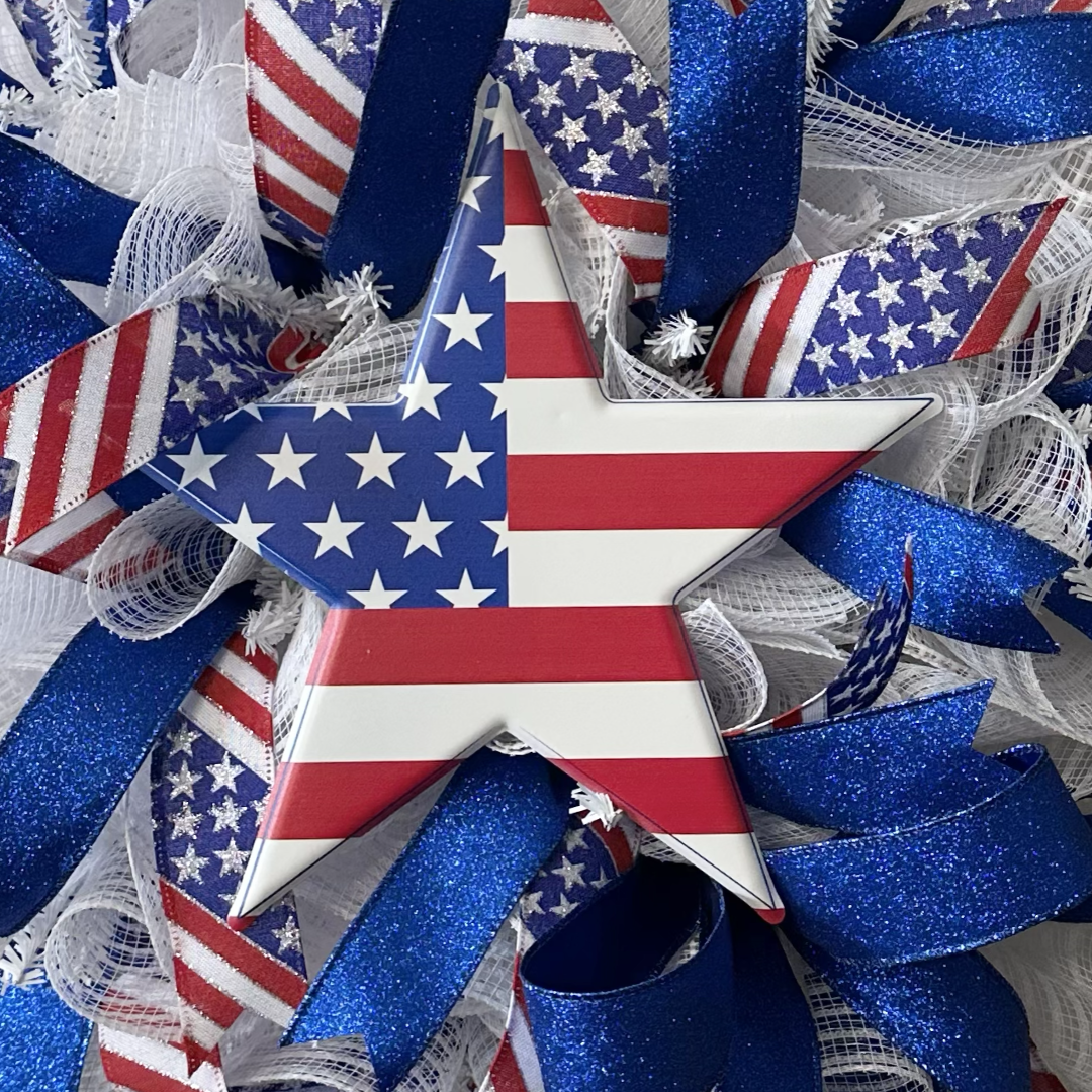Decorative wreath with American flag design and blue, red, and white ribbons 
