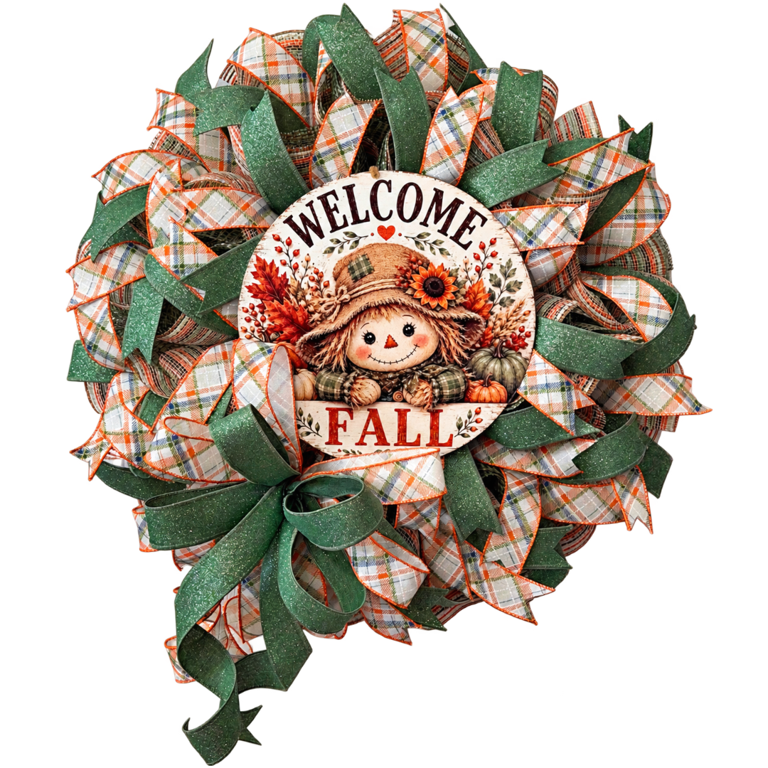 Deco mesh and ribbon wreath by Monkey's Creations featuring a "welcome fall" scarecrow metal wreath sign center accented by sage green wired ribbon and orange and blue plaid wired ribbon. 