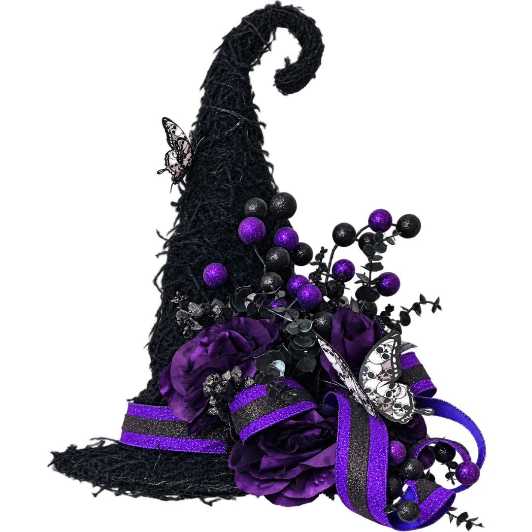 A decorative witch hat door hanger with a tall black brim, purple and black glitter ribbon, purple artificial roses, black and purple round glitter balls and butterfly embellishments on a plain white background by Monkey's Creations. 