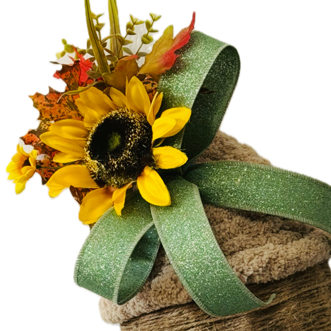 A chunky yarn and twine acorn door hanger or wreath attachment embellished with fall foliage, sunflowers and sage glitter wire ribbon by Monkey's Creations. 