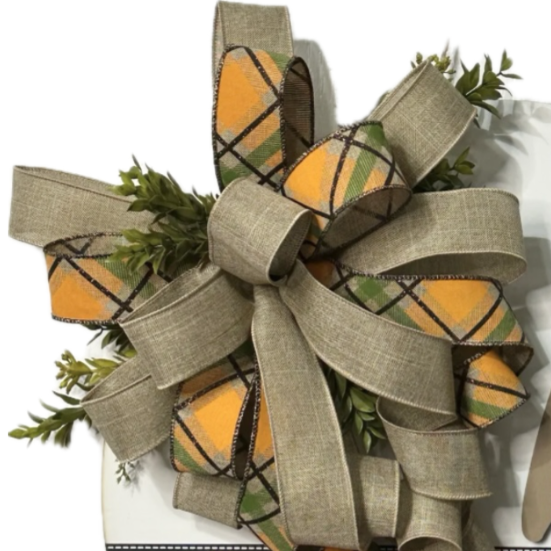 orange, black and beige hi wreath board with pumpkins and a bow with foliage, focus on the bow