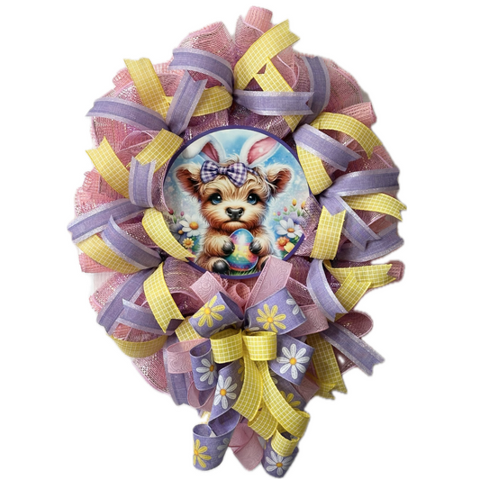Easter wreath with pastel ribbon and deco mesh a highland cow wearing bunny ears 