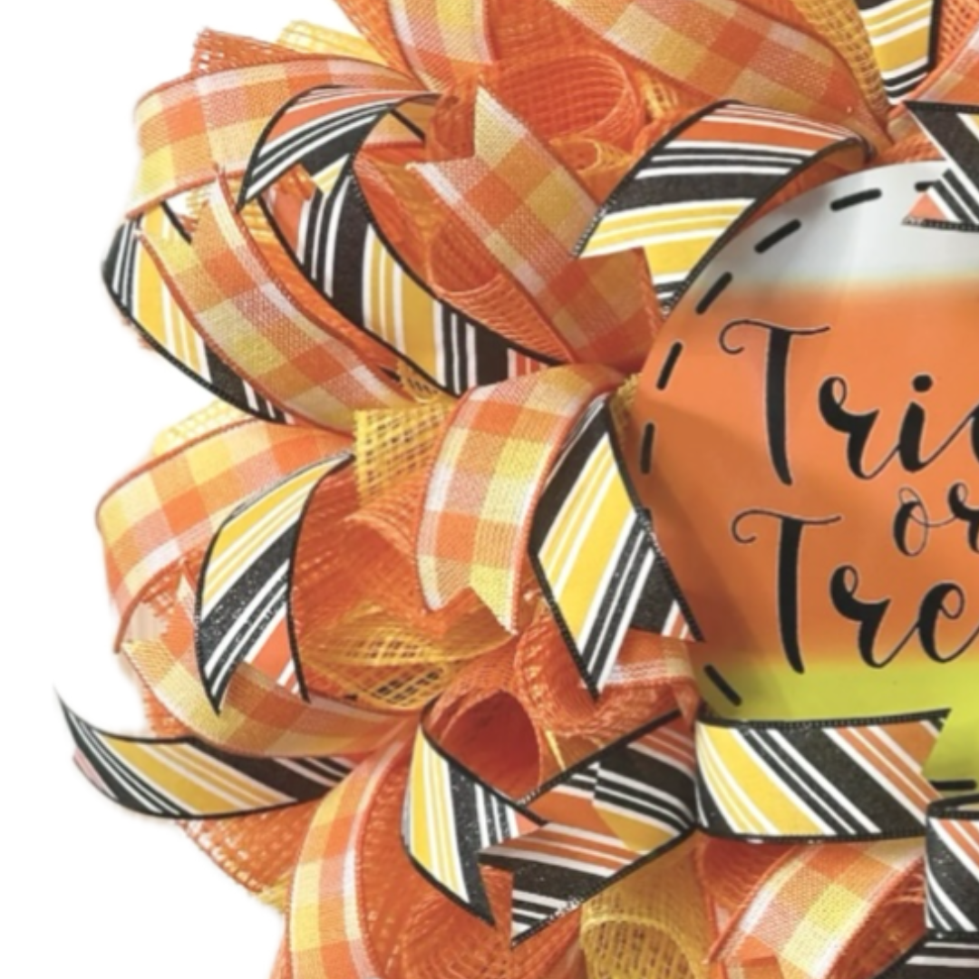 orange, black and yellow halloween candy corn trick or treat wreath, focus on ribbon and decomesh