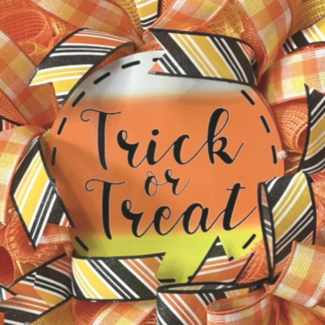 orange, black and yellow halloween candy corn trick or treat wreath, focus on wreath sign