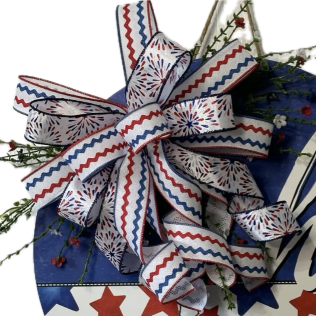 Patriotic round hi wreath with red white and blue starts and firework ribbon, focus on ribbon
