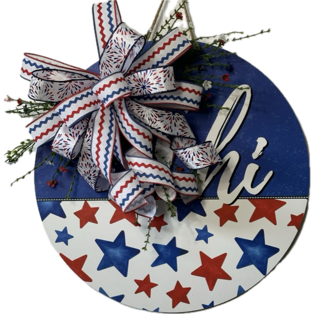 Patriotic round hi wreath with red white and blue starts and firework ribbon