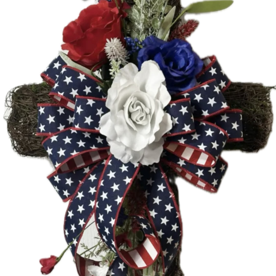 patriotic grapevine cross wreath with red white and blue roses and ribbon, focus on the ribbon