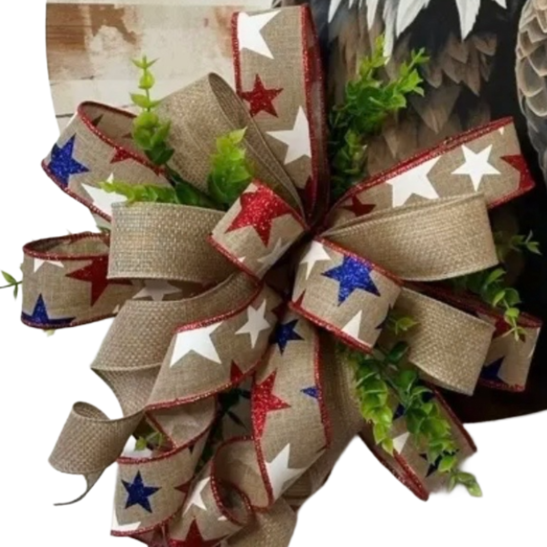Round bald eagle board wreath with patriotic ribbon and foliage, focus on the ribbon