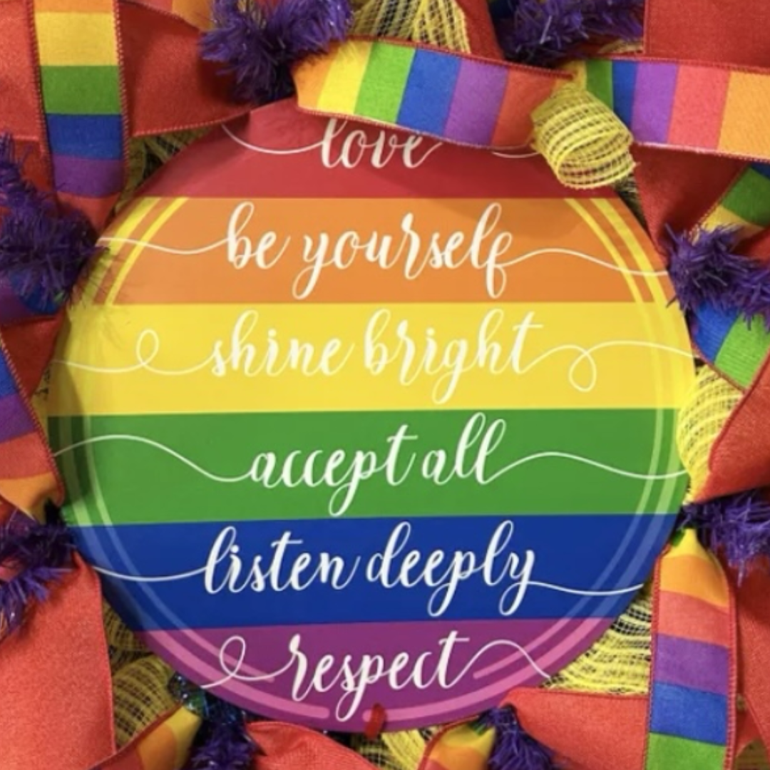 rainbow lgbtq2 wreath with ribbon and yellow deco mesh, focus on wreath sign