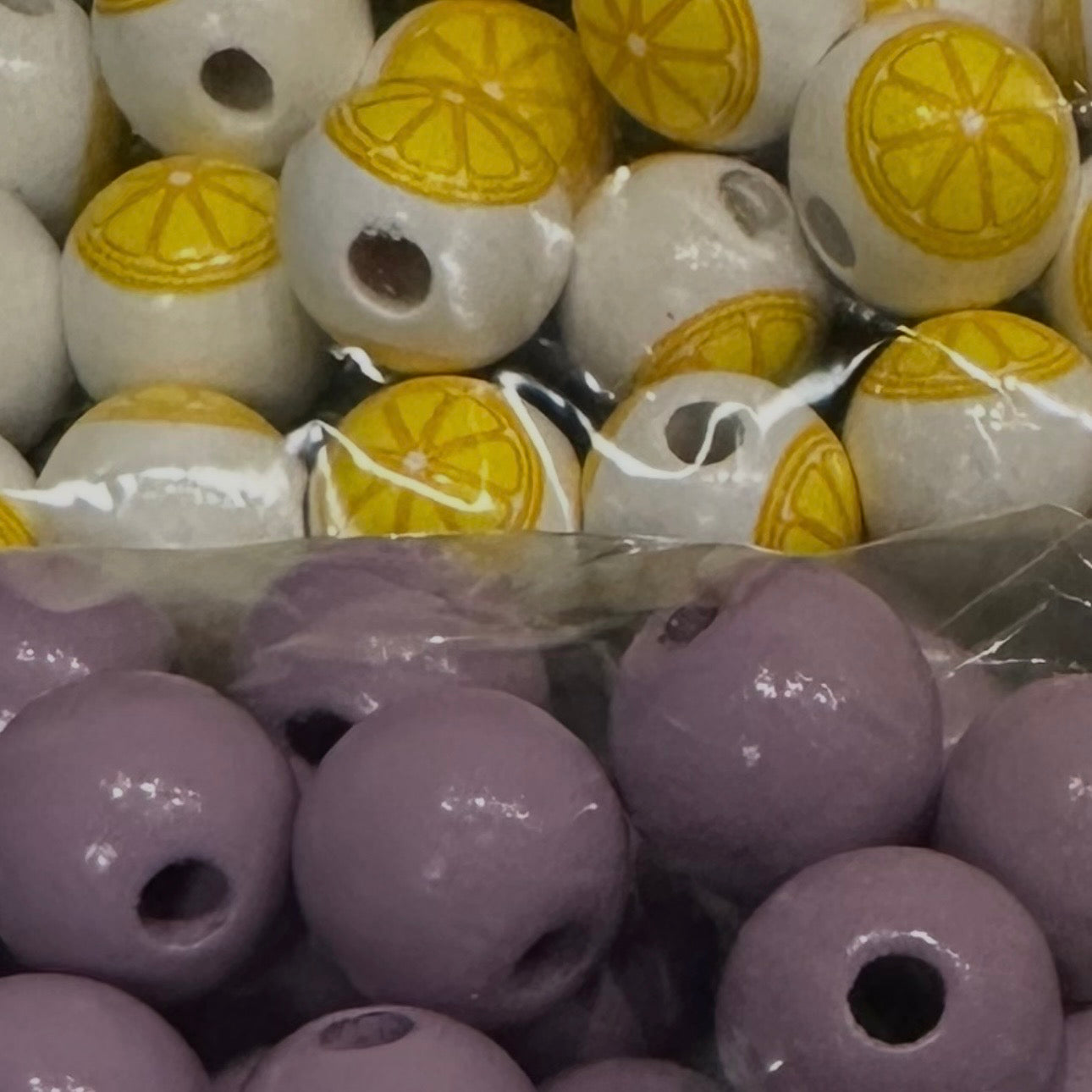 close up of light purple beads and white beads with lemon slices
